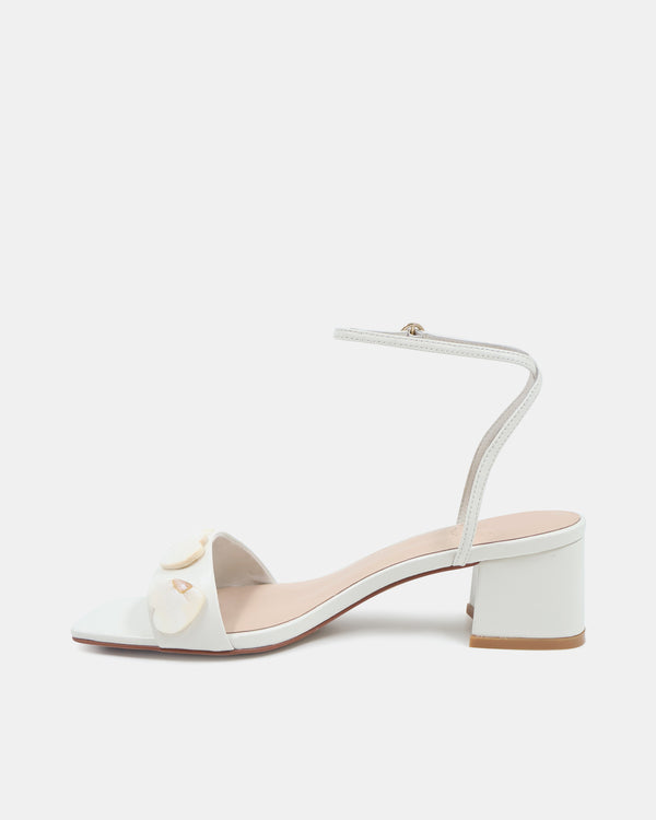 White sandal with a small bow on a white background