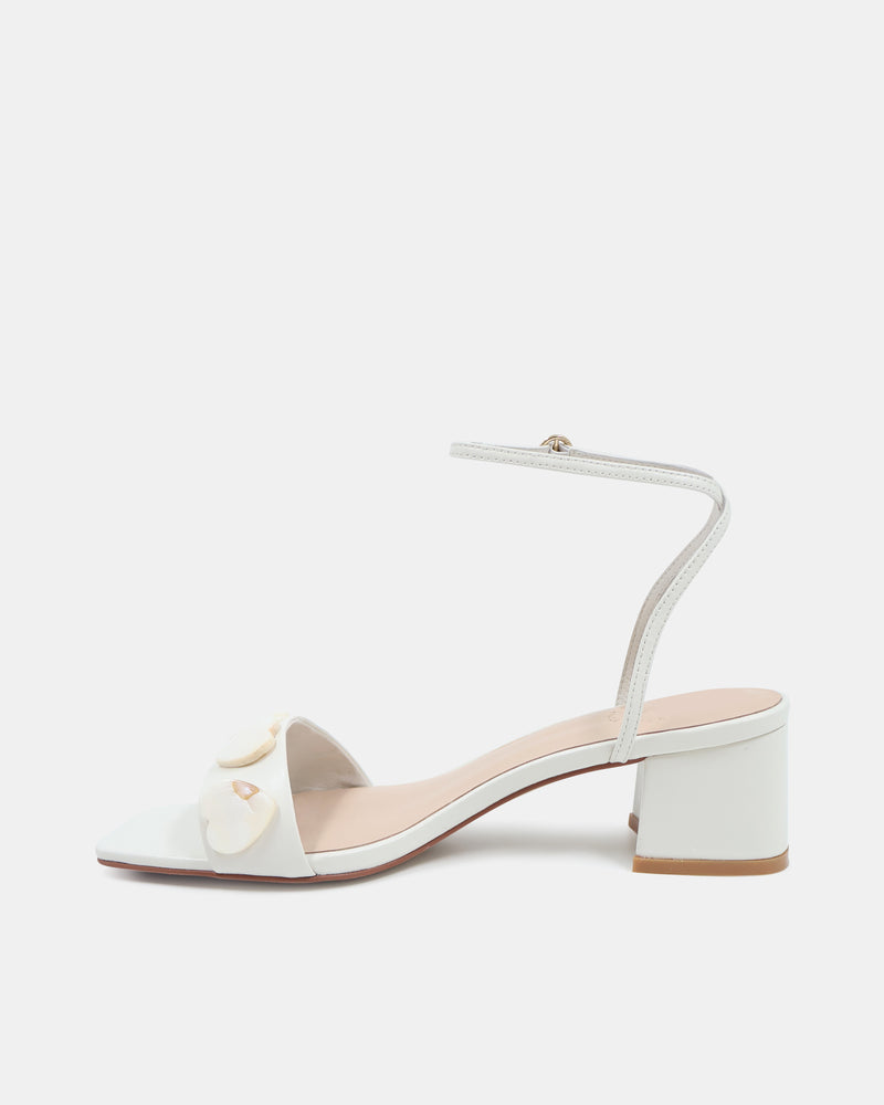 White sandal with a small bow on a white background