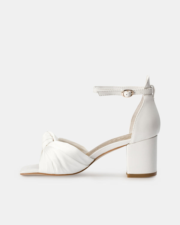 White sandal with block heel on a white background