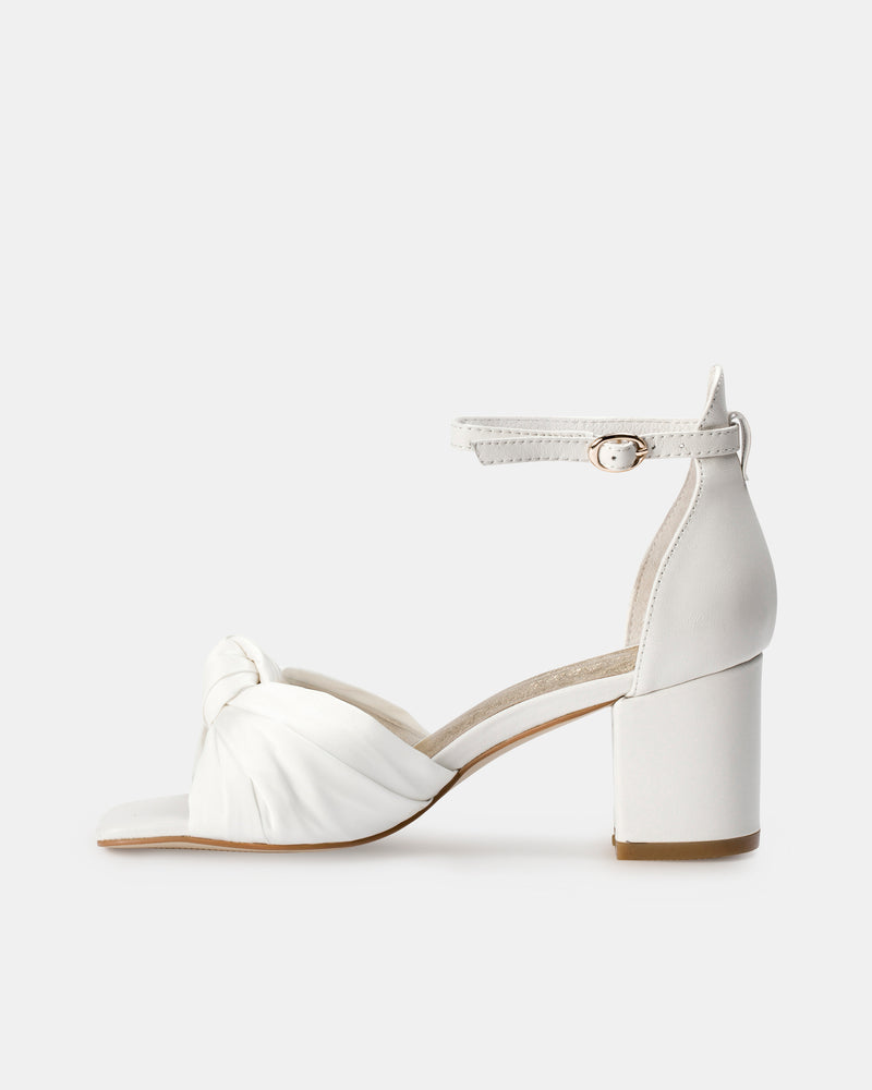 White sandal with block heel on a white background