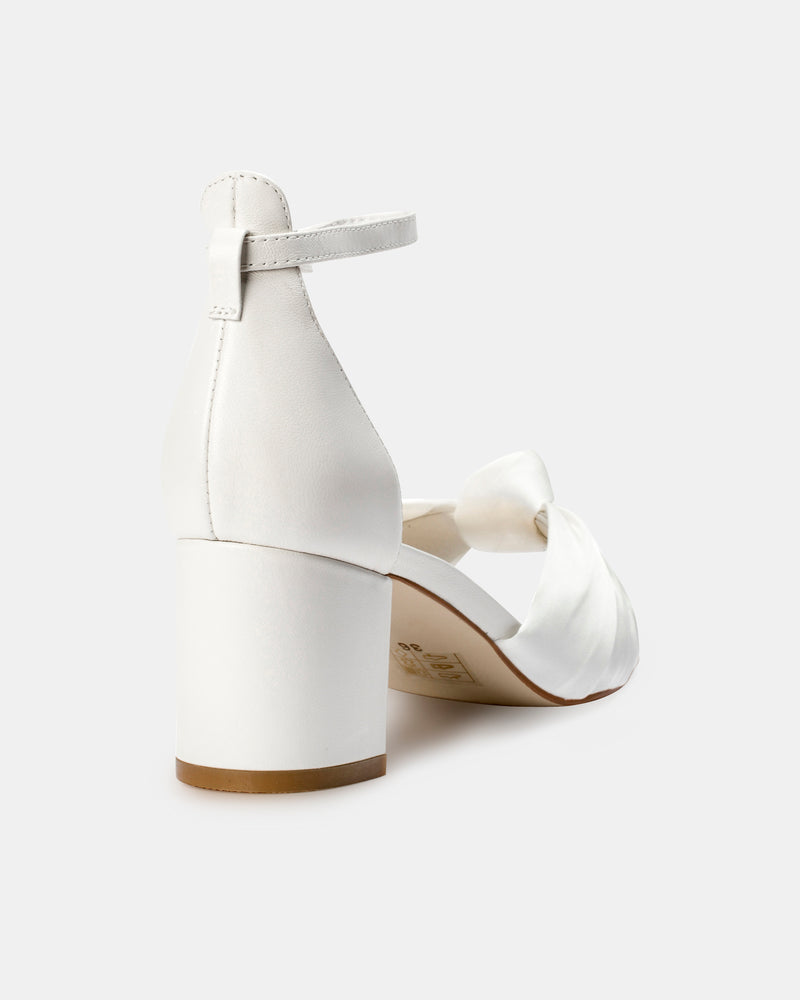 White sandal with a block heel on a white background