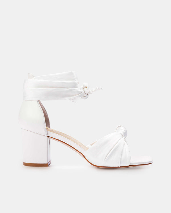 White high-heeled shoe with clear block heel on a white background