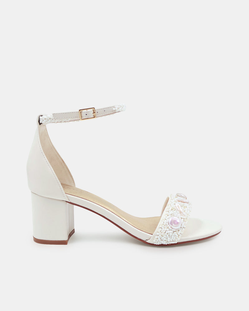 White sandal with block heel on a white background