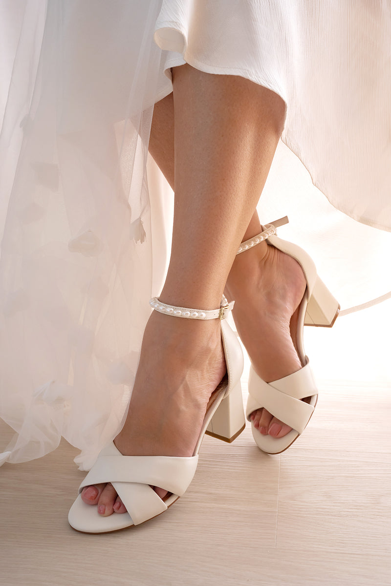 Ivory Satin Bridal Shoes with pearl ankle straps. 