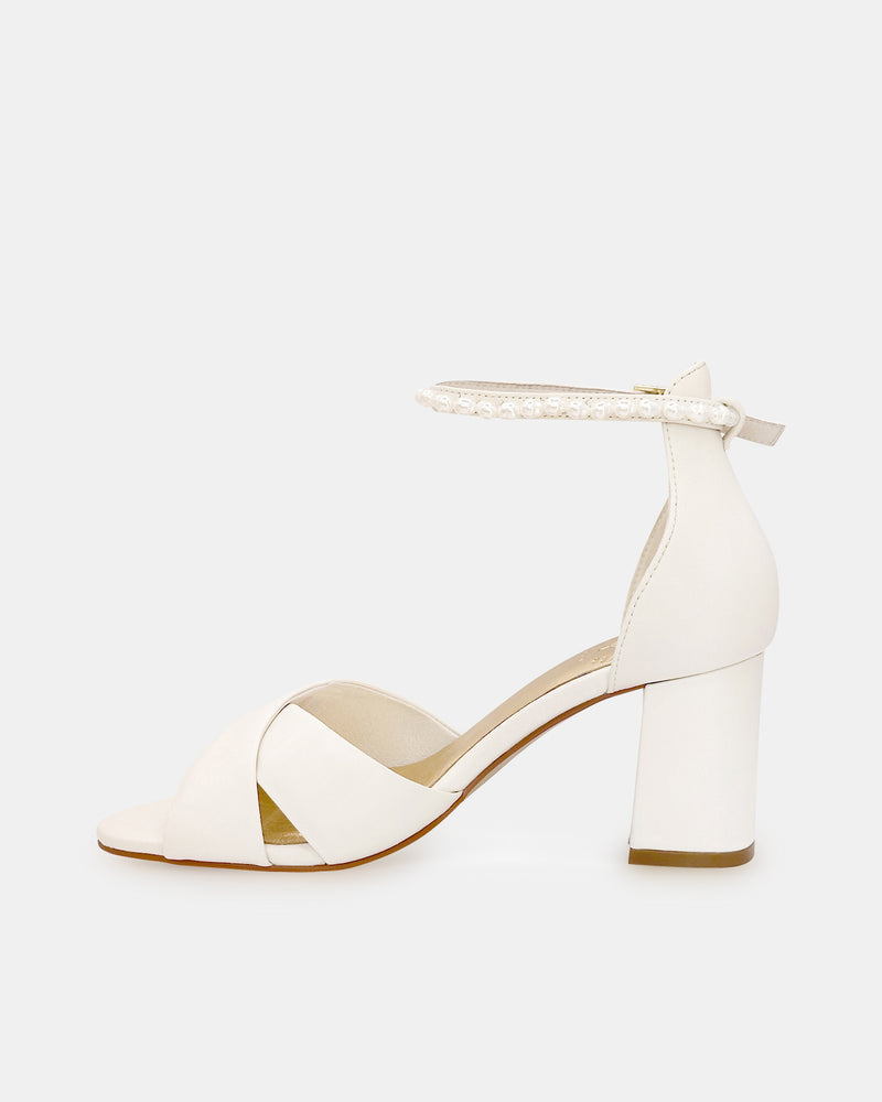Ivory bridal sandal with block heel and pearl ankle strap on a white background