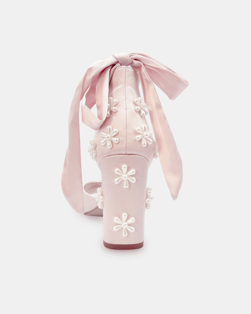Pink high-heeled shoes with floral designs and ribbons on a white background