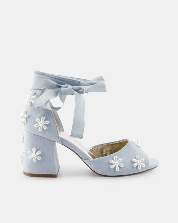 Light blue high-heeled shoes with floral embroidery on a white background