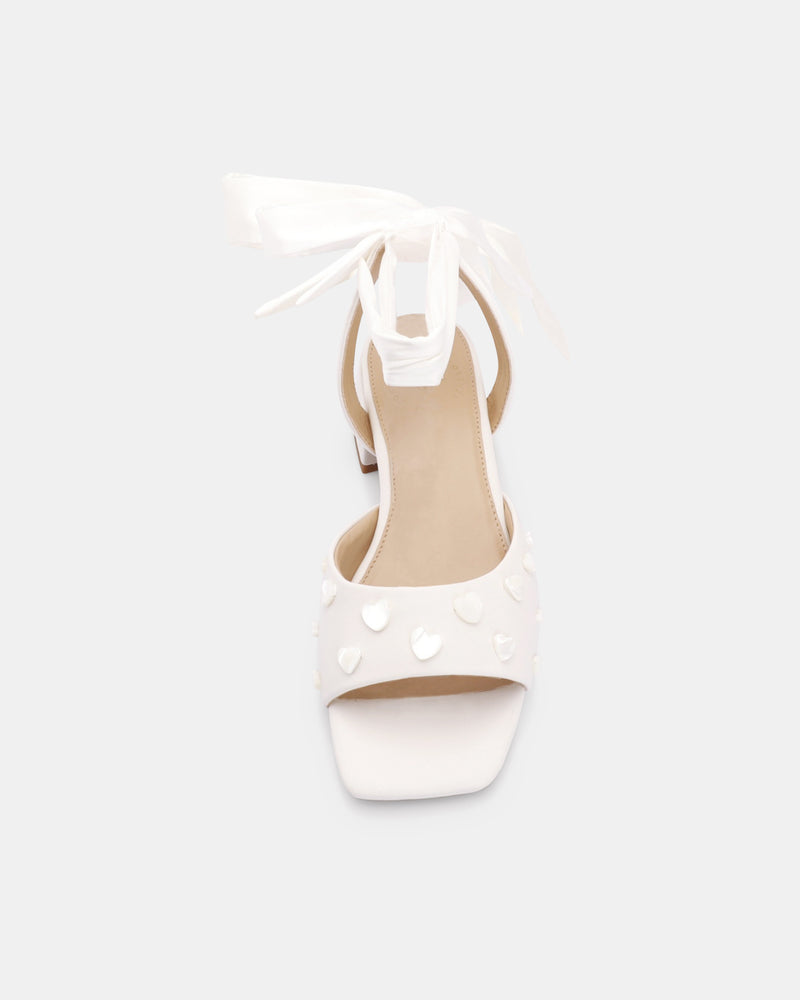White sandal with cut-out design on a white background