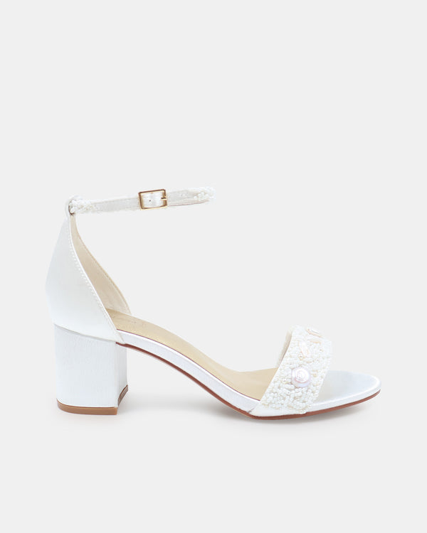 White sandal with a block heel on a white background