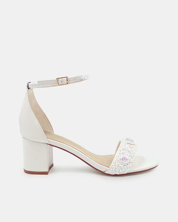 White sandal with block heel on a white background