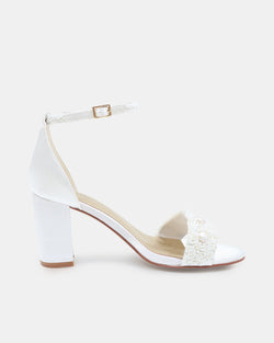 White sandal with block heel and decorative bow on a white background