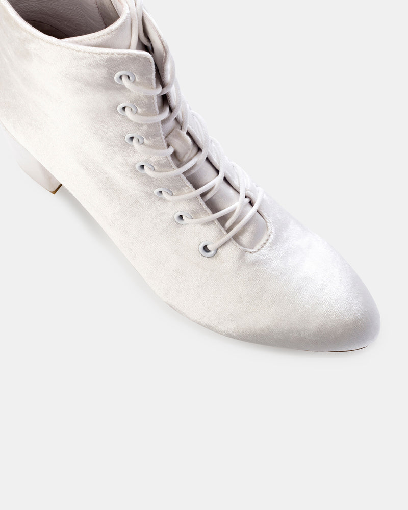 White velvet lace-up ankle boot on a white background
