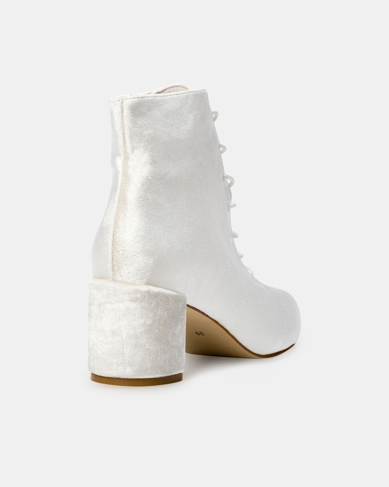 White velvet lace-up ankle boot on a white background