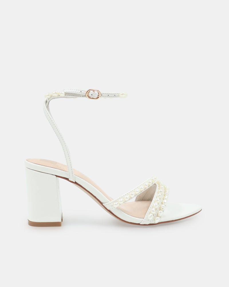 White sandal with block heel and pearl embellishments on a white background