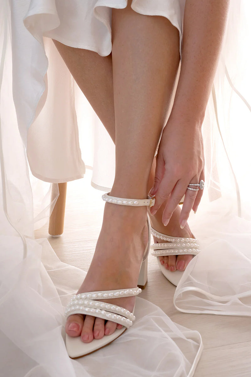 Pearl beaded bridal shoes worn by model for wedding day