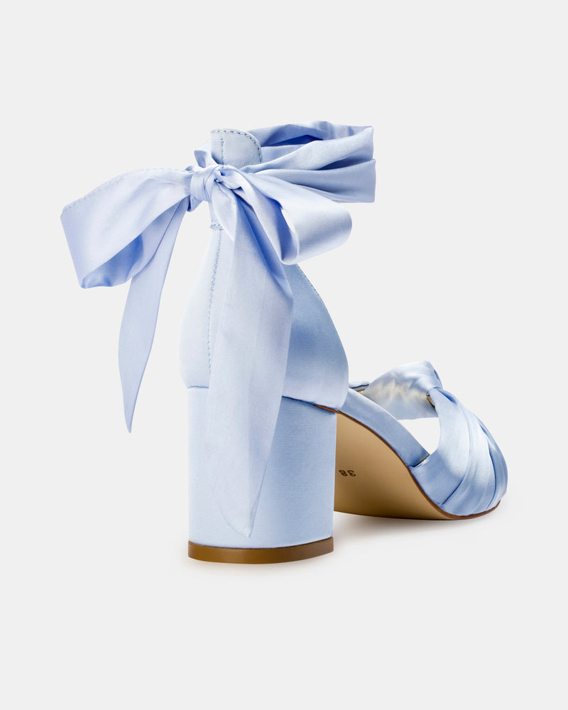 Light blue high-heeled shoes with ribbon details on a white background